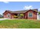 Charming single-story home featuring a well-manicured lawn and an inviting, colorful facade at 2665 E Juliet Dr, Deltona, FL 32738