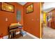 Hallway with orange colored walls, decor, and tile floor at 2665 E Juliet Dr, Deltona, FL 32738