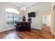 Home bar featuring a dark wood bar, stools, and a mounted television at 27127 Stoney Brook Dr, Leesburg, FL 34748