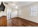 This bedroom features wood flooring, plantation shutters and an exterior patio door at 27127 Stoney Brook Dr, Leesburg, FL 34748