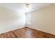 Bedroom featuring wood floors, a ceiling fan, and window with shutters at 27127 Stoney Brook Dr, Leesburg, FL 34748