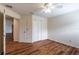 Bedroom featuring wood floors, a ceiling fan, and closet at 27127 Stoney Brook Dr, Leesburg, FL 34748