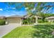 Charming single-story home with a well-maintained lawn and attached two-car garage at 27127 Stoney Brook Dr, Leesburg, FL 34748