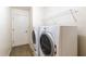 Laundry room with washer, dryer, and shelving for storage at 27127 Stoney Brook Dr, Leesburg, FL 34748