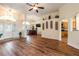 Open-concept living room with hardwood floors, wet bar, and decorative wall features at 27127 Stoney Brook Dr, Leesburg, FL 34748