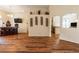 Open-concept living room showcases wood floors, built-in bar, and kitchen/dining room access at 27127 Stoney Brook Dr, Leesburg, FL 34748
