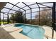 Enclosed pool featuring clear blue water and a beautiful view of the trees at 27127 Stoney Brook Dr, Leesburg, FL 34748