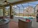 Enclosed pool area featuring stylish wicker furniture and beautiful backyard views at 27127 Stoney Brook Dr, Leesburg, FL 34748