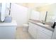 Bright bathroom featuring white vanity with crystal knobs and tile flooring in a neutral palette at 280 Celebration Blvd # 208, Kissimmee, FL 34747