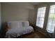 Bright bedroom featuring a comfy futon with white cushions and two windows offering natural light at 280 Celebration Blvd # 208, Kissimmee, FL 34747