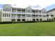 Elegant condo building featuring multiple balconies and a well-manicured lawn at 280 Celebration Blvd # 208, Kissimmee, FL 34747