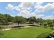 Well-maintained front yard with green lawn and mature trees at 280 Celebration Blvd # 208, Kissimmee, FL 34747