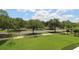Well-maintained front yard with green lawn and mature trees at 280 Celebration Blvd # 208, Kissimmee, FL 34747