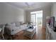 Bright living room featuring hardwood floors, neutral tones, and an open patio at 280 Celebration Blvd # 208, Kissimmee, FL 34747