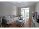 Bright living room featuring hardwood floors, neutral tones, and an open patio at 280 Celebration Blvd # 208, Kissimmee, FL 34747
