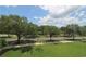 Scenic street view showcasing lush green trees and landscaping under a bright, partly cloudy sky at 280 Celebration Blvd # 208, Kissimmee, FL 34747