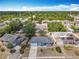 Aerial view of a gray roof home with an attached garage, surrounded by neighborhood greenery and other houses at 2818 Irondale St, Deltona, FL 32738