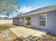 Backyard features a concrete patio, gray house exterior and sunny area at 2818 Irondale St, Deltona, FL 32738