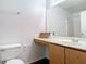 Functional bathroom with toilet, single sink vanity, and a large mirror at 2818 Irondale St, Deltona, FL 32738