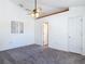 Spacious bedroom featuring neutral carpet, a ceiling fan, and multiple closets at 2818 Irondale St, Deltona, FL 32738