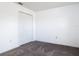 A clean bedroom featuring carpet, closet, and neutral colored walls at 2818 Irondale St, Deltona, FL 32738