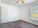 A well-lit bedroom features plush carpet flooring, a window with blinds, and a white door at 2818 Irondale St, Deltona, FL 32738