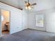 Bedroom featuring neutral carpet, a ceiling fan, and an ensuite bathroom at 2818 Irondale St, Deltona, FL 32738