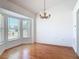 Bright dining room featuring large bay windows, hardwood floors, and modern chandelier at 2818 Irondale St, Deltona, FL 32738