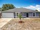 Charming one-story home featuring a new roof, attached garage, and decorative circular window at 2818 Irondale St, Deltona, FL 32738