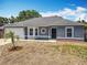Charming one-story home with a decorative circular window and an attached one car garage at 2818 Irondale St, Deltona, FL 32738