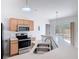Kitchen with stainless steel appliances, wood cabinets, and a view to the backyard at 2818 Irondale St, Deltona, FL 32738
