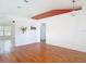 Spacious living room features hardwood floors, decorative wall cutouts, modern lighting and orange crown at 2818 Irondale St, Deltona, FL 32738