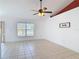 Spacious living room with tile flooring, ceiling fan, and natural light at 2818 Irondale St, Deltona, FL 32738