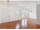 Spacious living room featuring hardwood floors, modern light fixtures, and large windows at 2818 Irondale St, Deltona, FL 32738