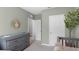 Bedroom with neutral tones, a changing table, and access to hallway and closet, designed for comfort at 3018 Salisbury Ave, Haines City, FL 33844