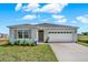Charming single-story home featuring a two-car garage, landscaped yard, and neutral color palette at 3018 Salisbury Ave, Haines City, FL 33844
