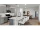 Contemporary kitchen equipped with a large island, stainless steel appliances, and gray cabinets at 3018 Salisbury Ave, Haines City, FL 33844