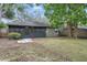 Spacious backyard with screened porch, mature trees, and partial privacy fence at 3204 Amherst Ave, Orlando, FL 32804