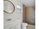 Clean bathroom featuring tiled shower, framed mirror, and white vanity at 3204 Amherst Ave, Orlando, FL 32804