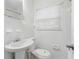 Bathroom with white tile, toilet and sink at 3204 Amherst Ave, Orlando, FL 32804