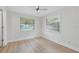 Bright bedroom with light walls, wood-look floors, and two windows with natural light at 3204 Amherst Ave, Orlando, FL 32804