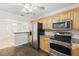 Well-lit kitchen with stainless steel appliances, granite countertops, and wooden cabinetry at 3204 Amherst Ave, Orlando, FL 32804