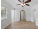 Bright living room with laminate flooring, ceiling fan and a window letting in natural light at 3204 Amherst Ave, Orlando, FL 32804