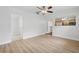 Spacious living room with laminate flooring, ceiling fan and open access to other rooms at 3204 Amherst Ave, Orlando, FL 32804