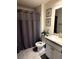 Well-maintained bathroom with granite countertop and shower with gray curtain at 321 Jovana Rd, Davenport, FL 33837