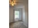 Bright bedroom featuring a large window, neutral carpet, and a spacious closet at 321 Jovana Rd, Davenport, FL 33837