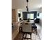 Open concept dining area flows seamlessly, featuring a modern light fixture and stylish decor at 321 Jovana Rd, Davenport, FL 33837