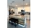 Open kitchen with an island, granite countertops, stainless steel appliances, and ample storage space at 321 Jovana Rd, Davenport, FL 33837