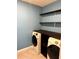 Functional laundry room with blue walls, stacked Samsung washer and dryer, and shelving for storage at 321 Jovana Rd, Davenport, FL 33837