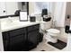 Well-lit bathroom with a dark vanity, white sink, and decorative accents at 416 Calabria Ave, Davenport, FL 33897